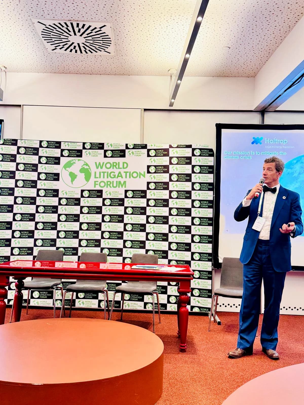 Speaker on stage in front of WLF branding at Europe 2024